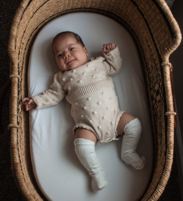 A peaceful scene with a cozy baby in a cradle